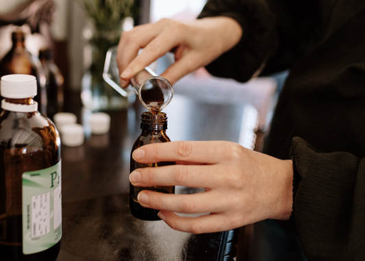 spring allergies blog post image herbal medicine blending pouring into bottle