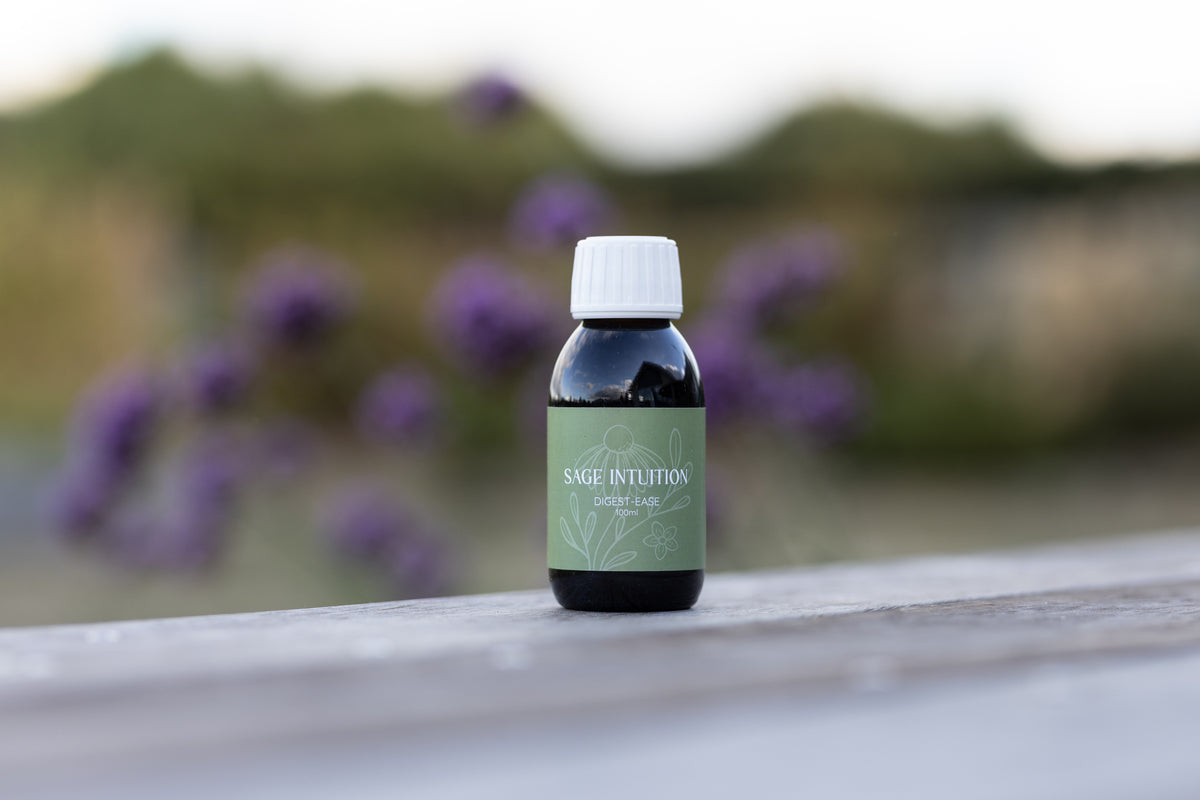 Sage Intuition Digest-Ease herbal tincture bottle with a pale green label and white cap, pictured outdoors.